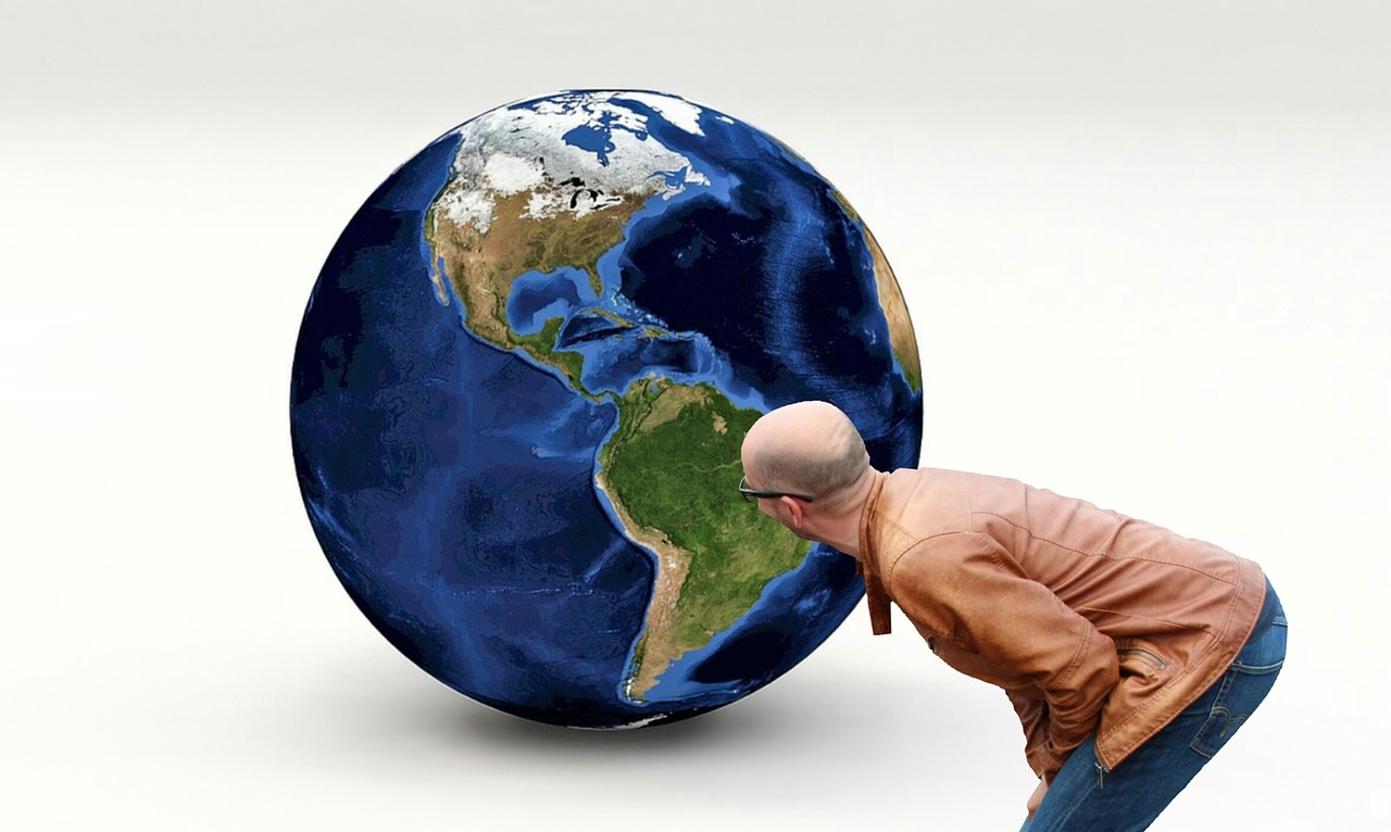 A man looking at a globe of earth