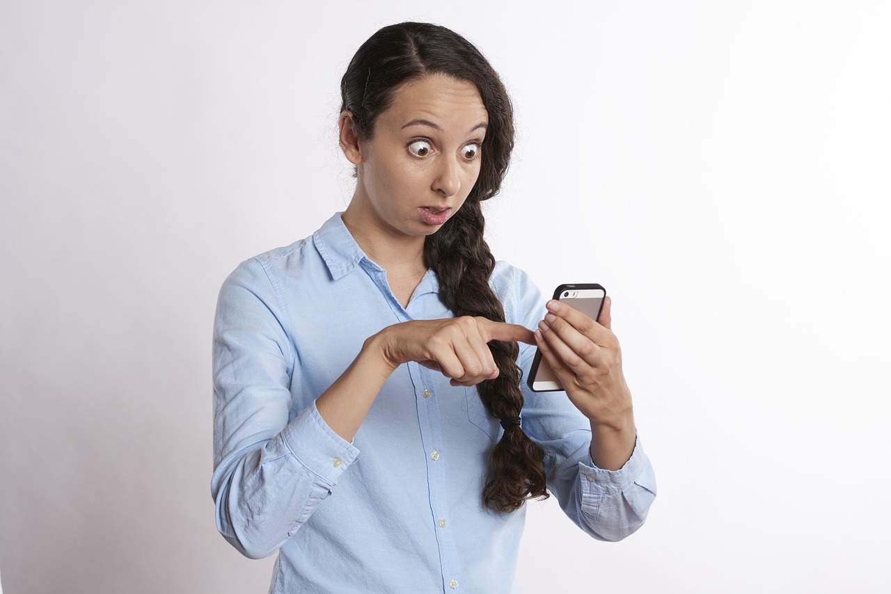 woman pointing at smartphone