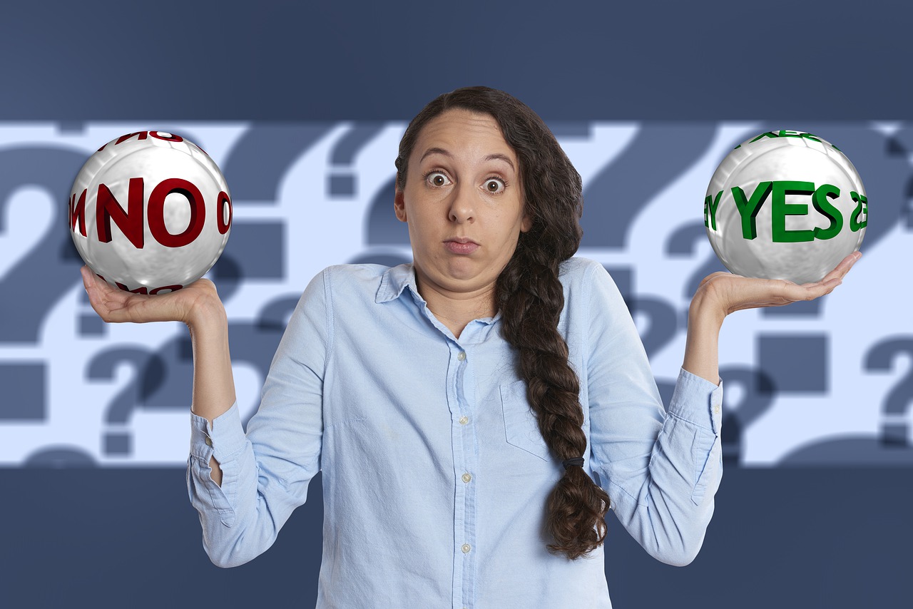 a woman holding a no ball in one hand and a yes ball in the other hand