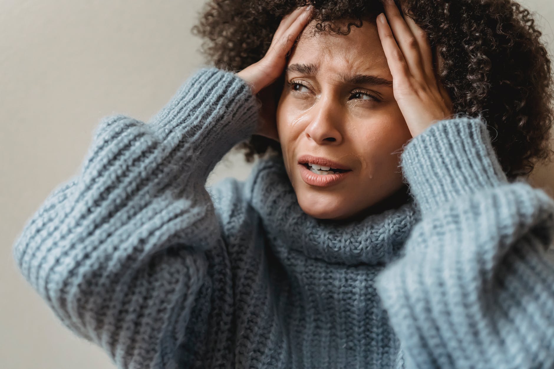 disappointed black woman crying and touching head